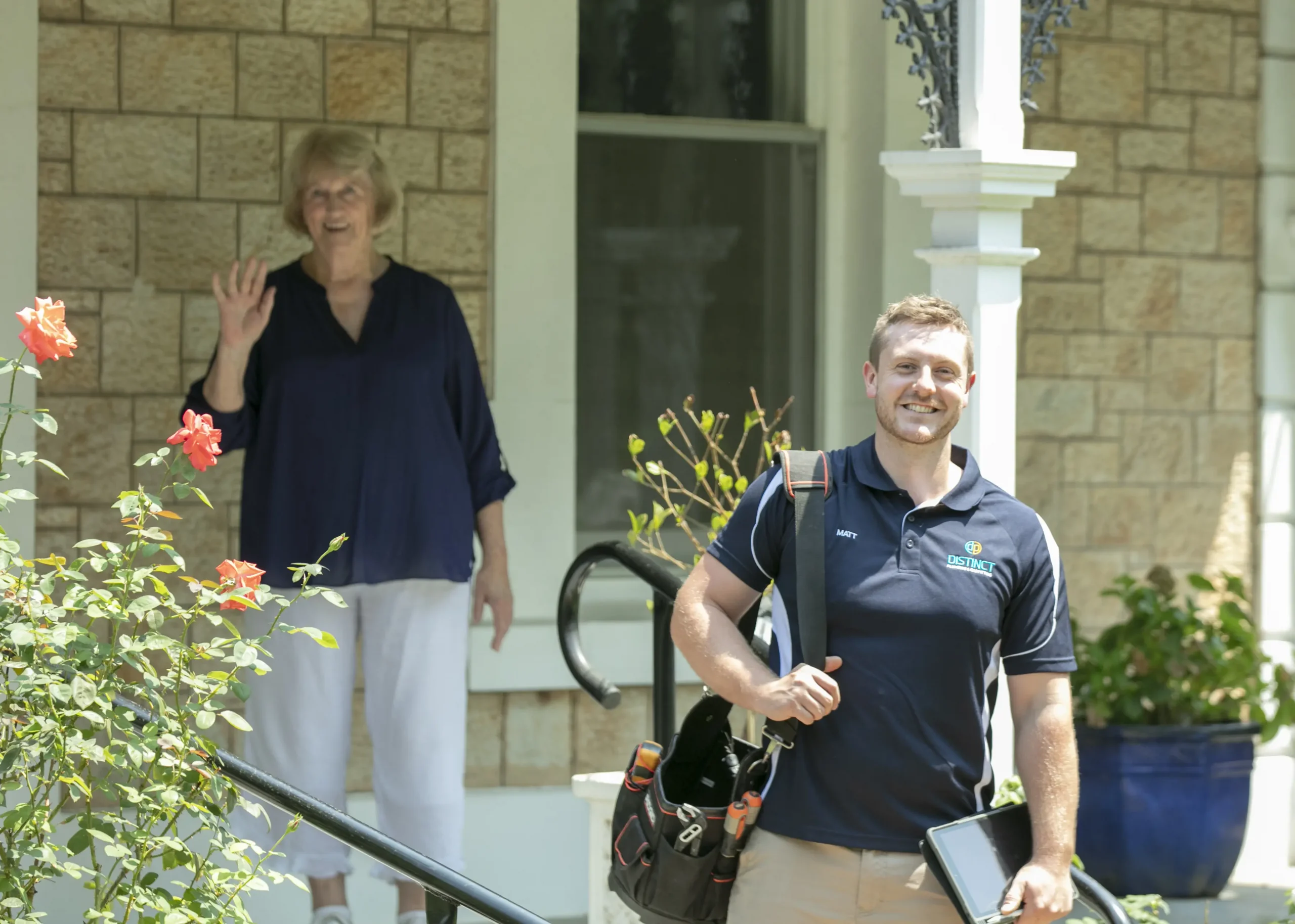 A plumber inspecting a modern hot water system installation in a residential property.
