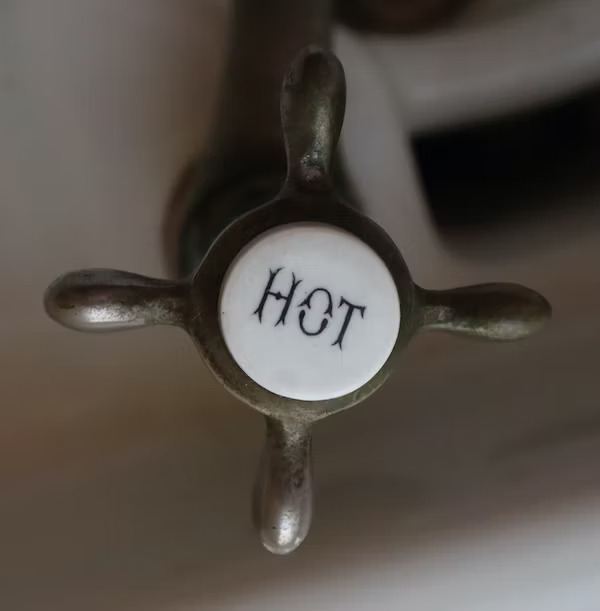 A modern hot water system featuring an energy-efficient heat pump and solar panels on the rooftop, providing sustainable water heating solutions.