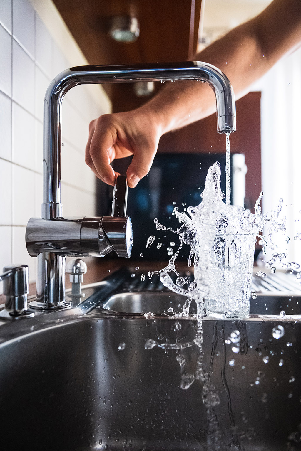 A professional plumber installing a contemporary hot water system in a residential property.
