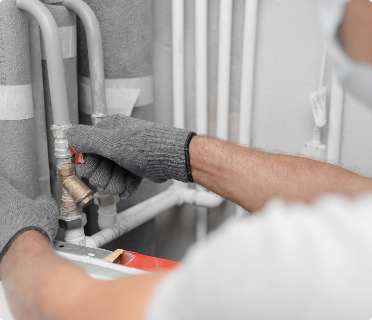 A plumber performing repair and maintenance of plumbing systems at home.